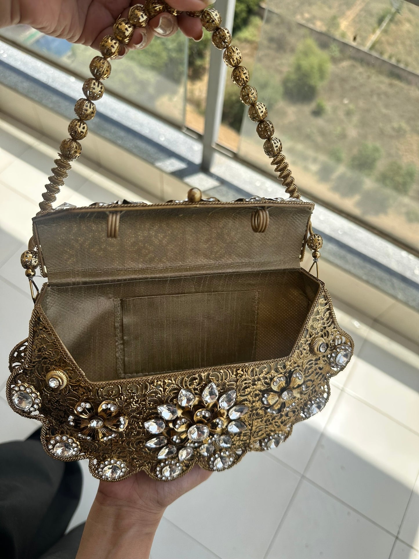 The Antique Gold Scalloped Filigree Clutch with Crystal Floral Medallions