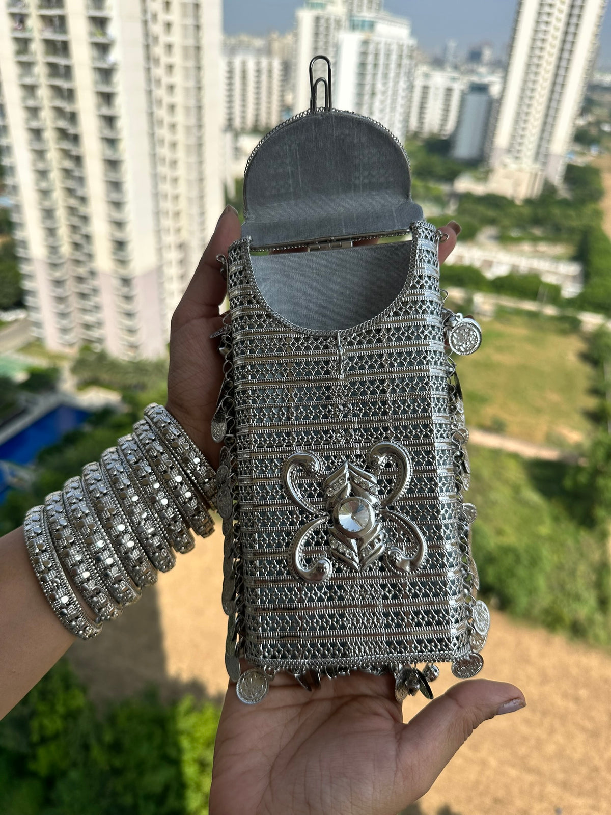 The SITARA Handcrafted Metal Phone Crossbody Clutch with Sunburst Crystal & Coin Charms