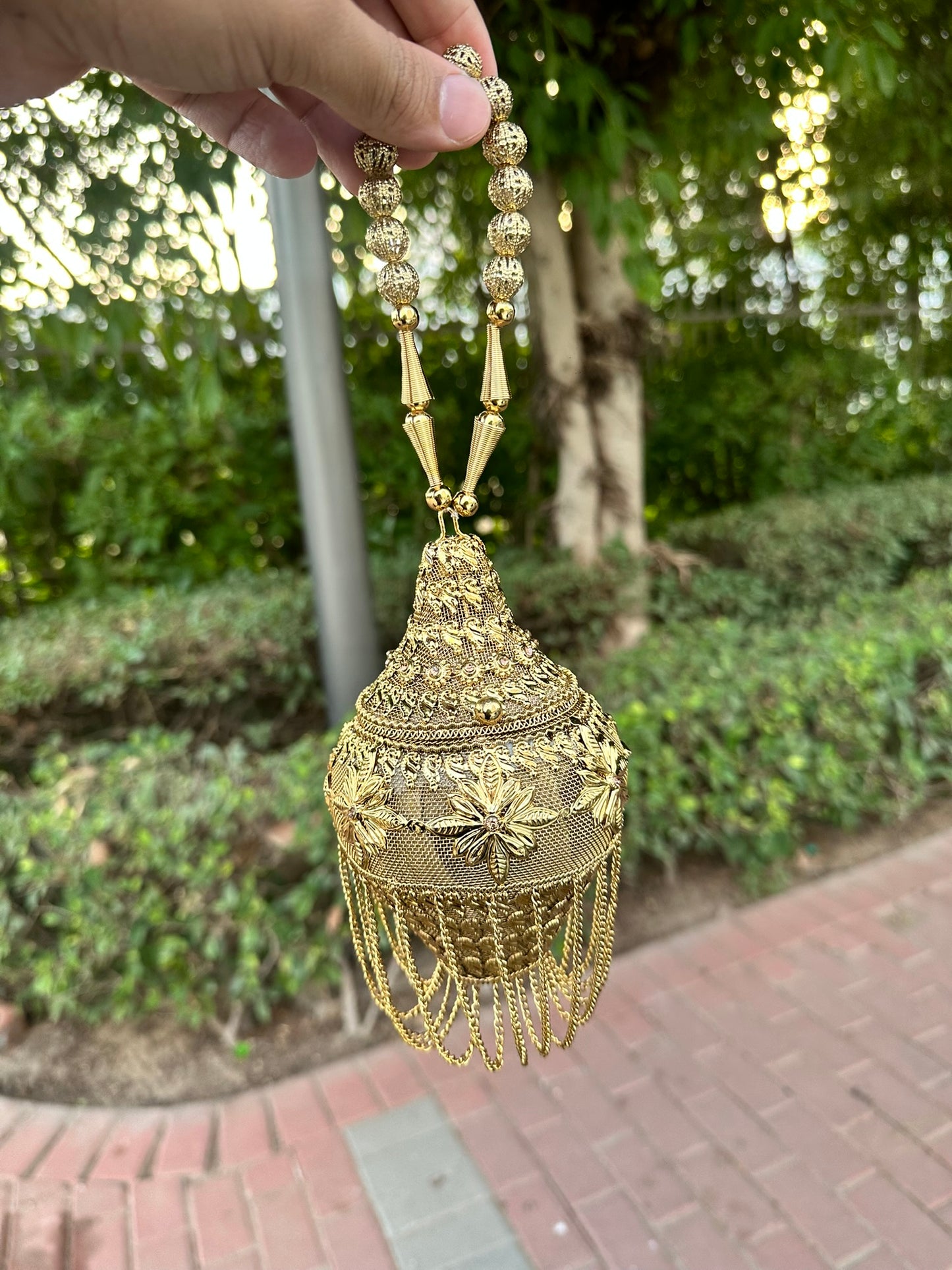 Gold Filigree Mini Potli Clutch - Vintage-Inspired Metal Minaudière with Floral Detail and Fringe Tassels