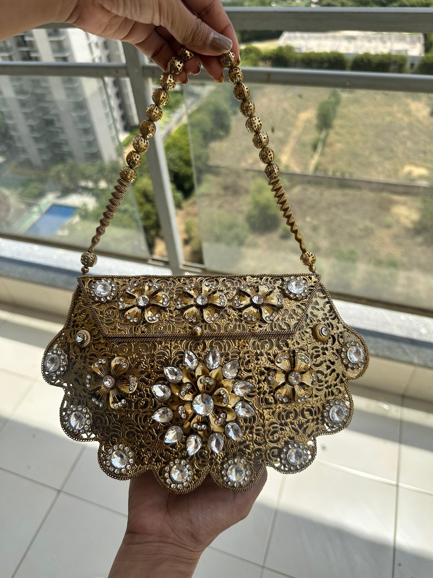 The Antique Gold Scalloped Filigree Clutch with Crystal Floral Medallions