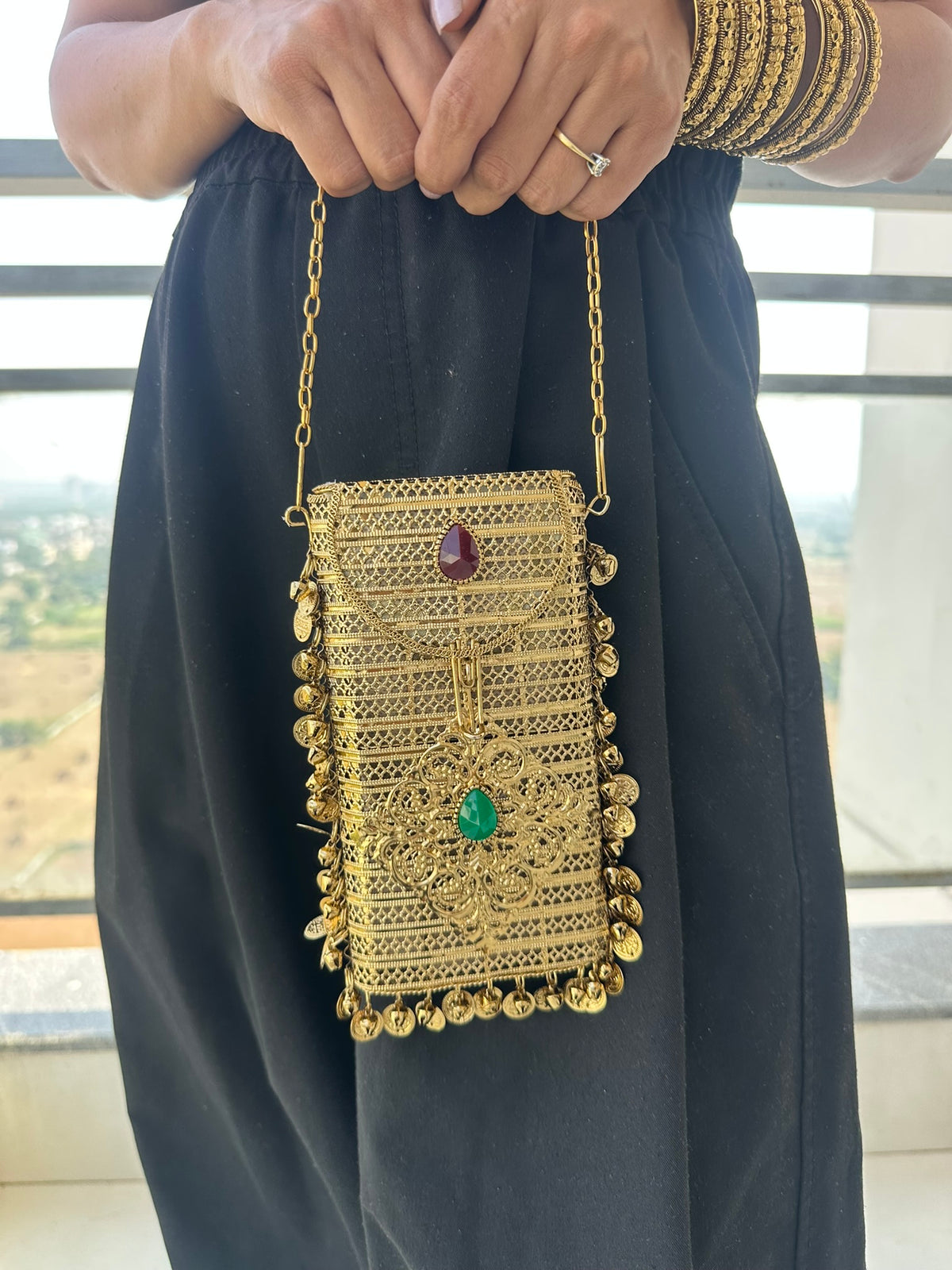 The NAYA Handcrafted Metal Phone Crossbody Clutch with Gemstones & Coin Charms