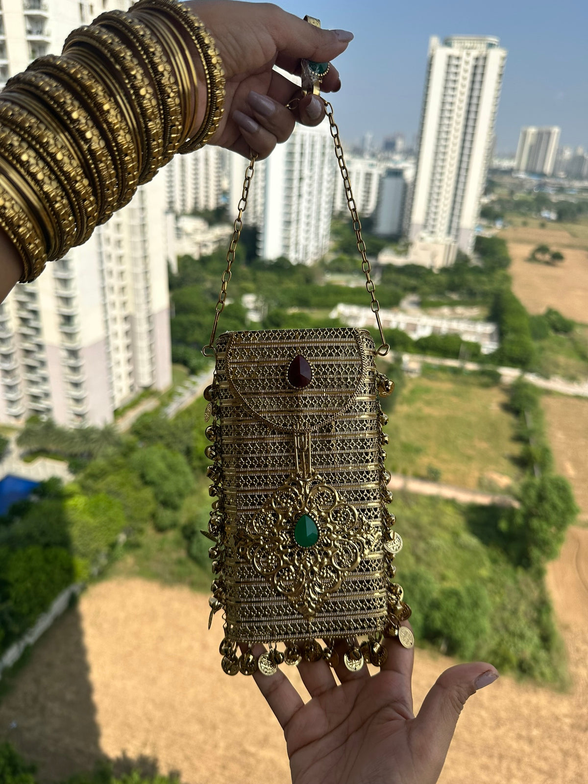 The NAYA Handcrafted Metal Phone Crossbody Clutch with Gemstones & Coin Charms