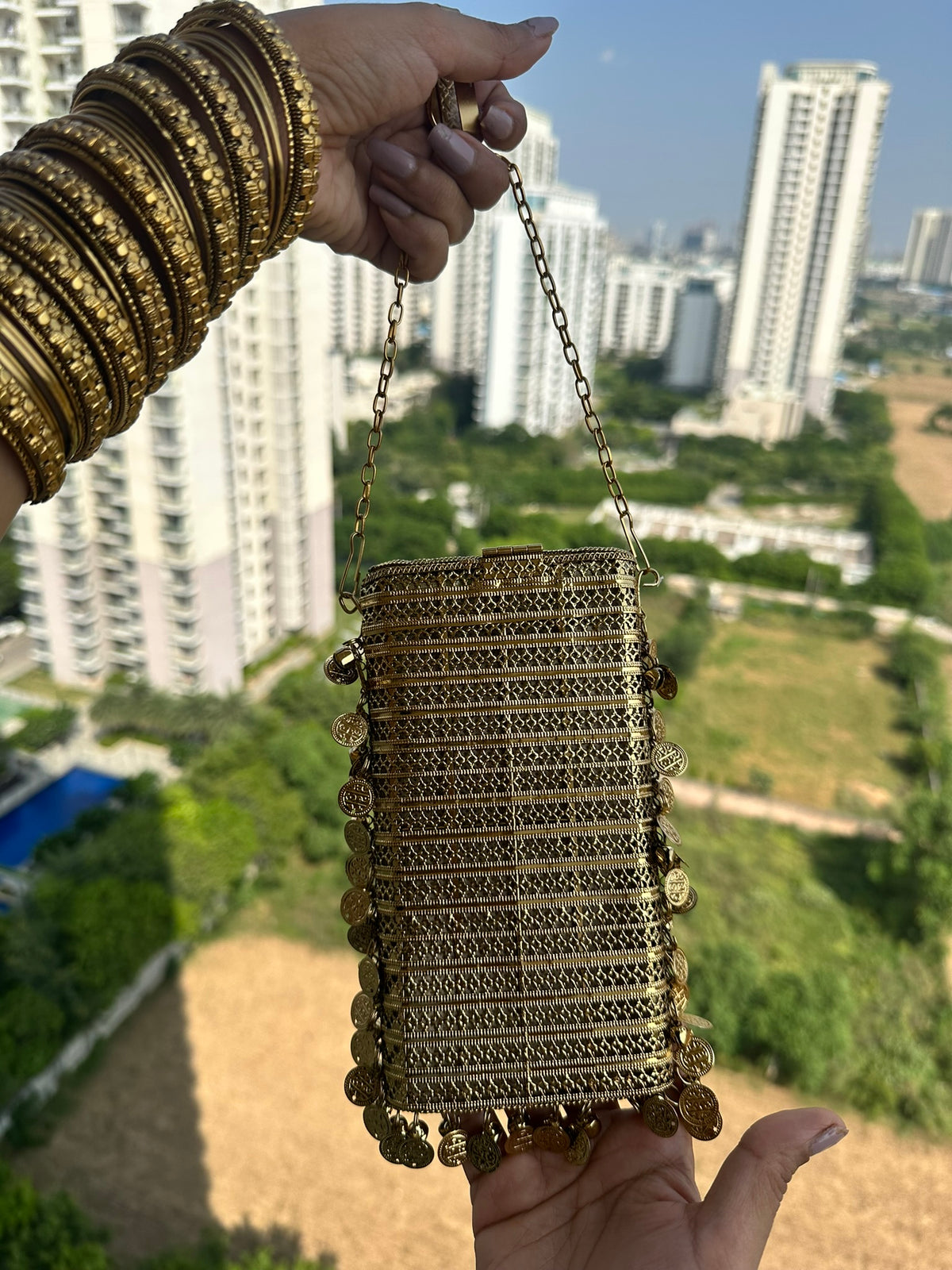 The NAYA Handcrafted Metal Phone Crossbody Clutch with Gemstones & Coin Charms