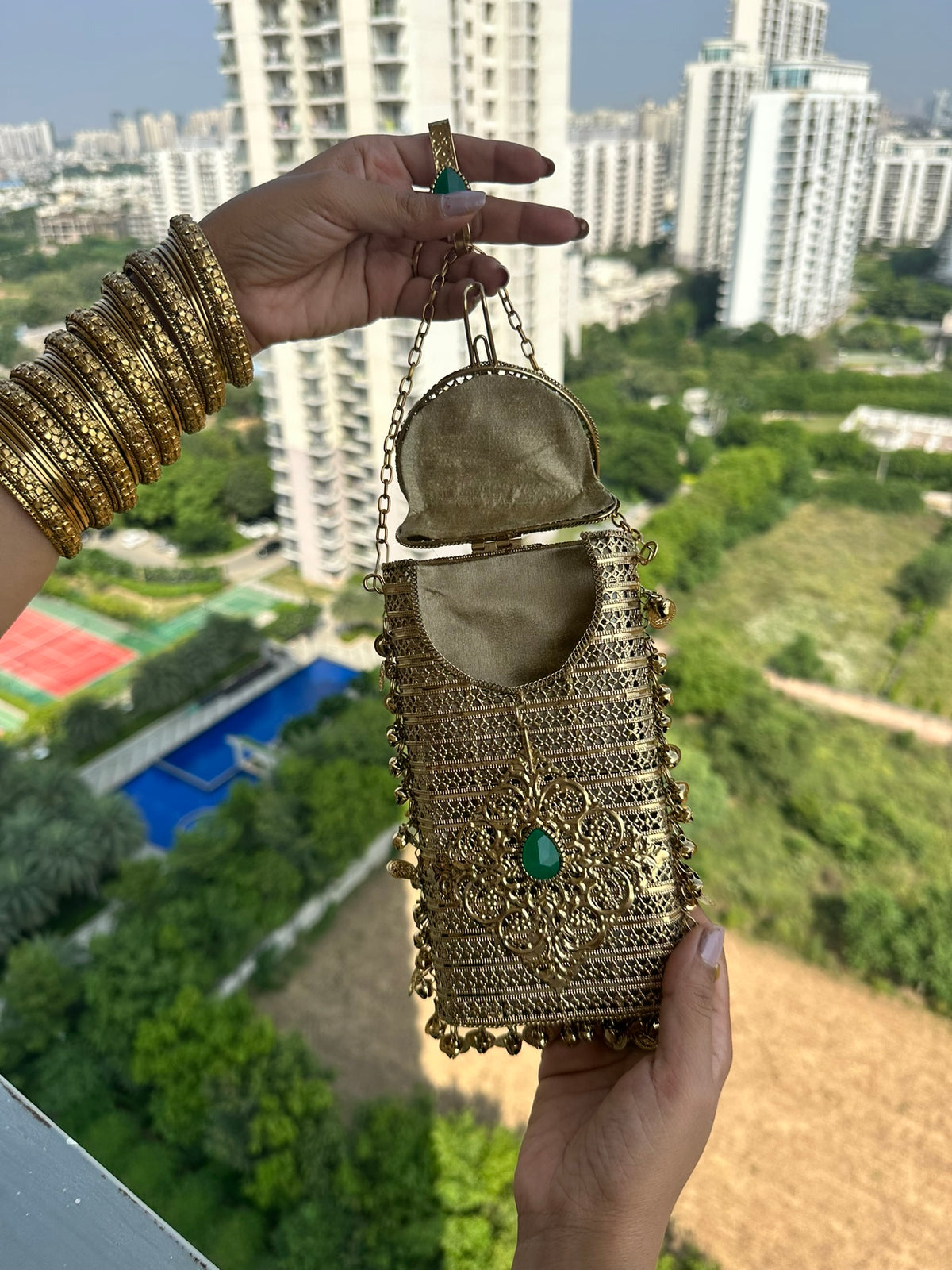 The NAYA Handcrafted Metal Phone Crossbody Clutch with Gemstones & Coin Charms