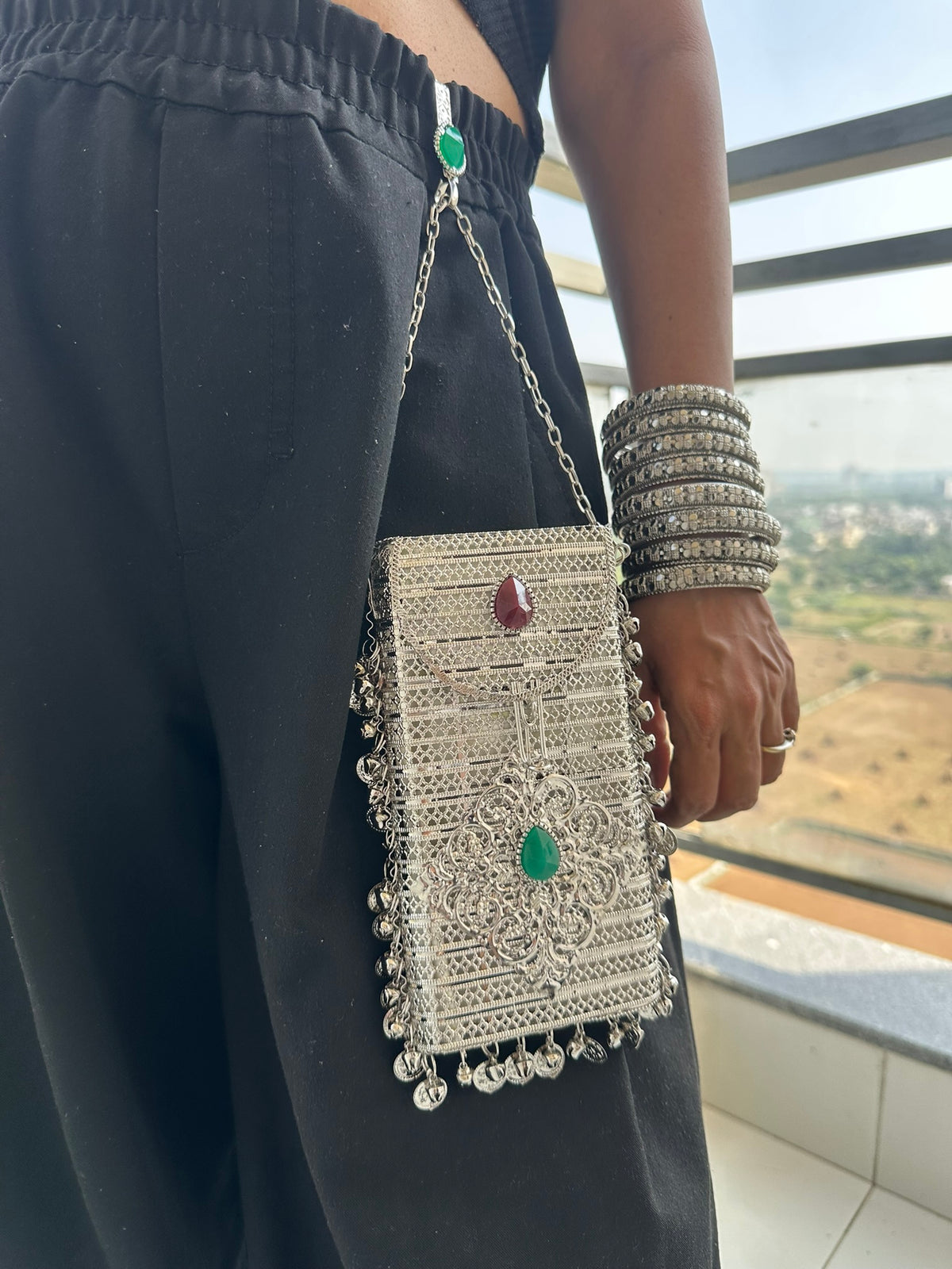The NAYA Handcrafted Metal Phone Crossbody Clutch with Gemstones & Coin Charms