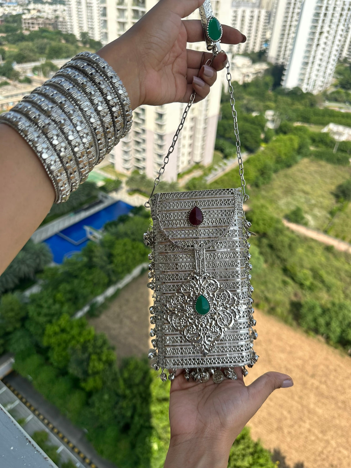 The NAYA Handcrafted Metal Phone Crossbody Clutch with Gemstones & Coin Charms