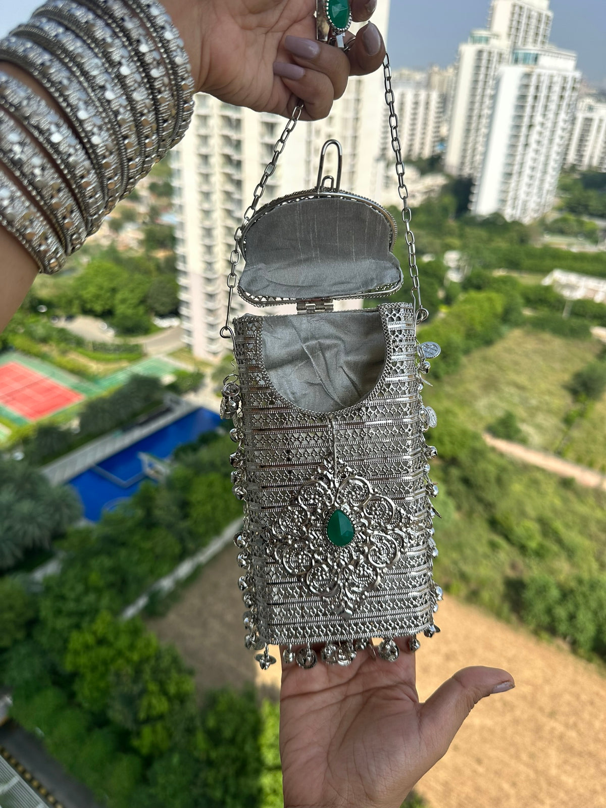 The NAYA Handcrafted Metal Phone Crossbody Clutch with Gemstones & Coin Charms