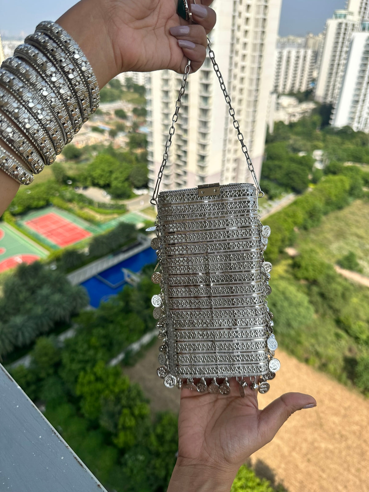 The NAYA Handcrafted Metal Phone Crossbody Clutch with Gemstones & Coin Charms