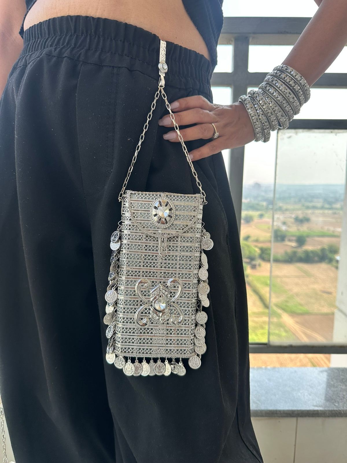 The SITARA Handcrafted Metal Phone Crossbody Clutch with Sunburst Crystal & Coin Charms