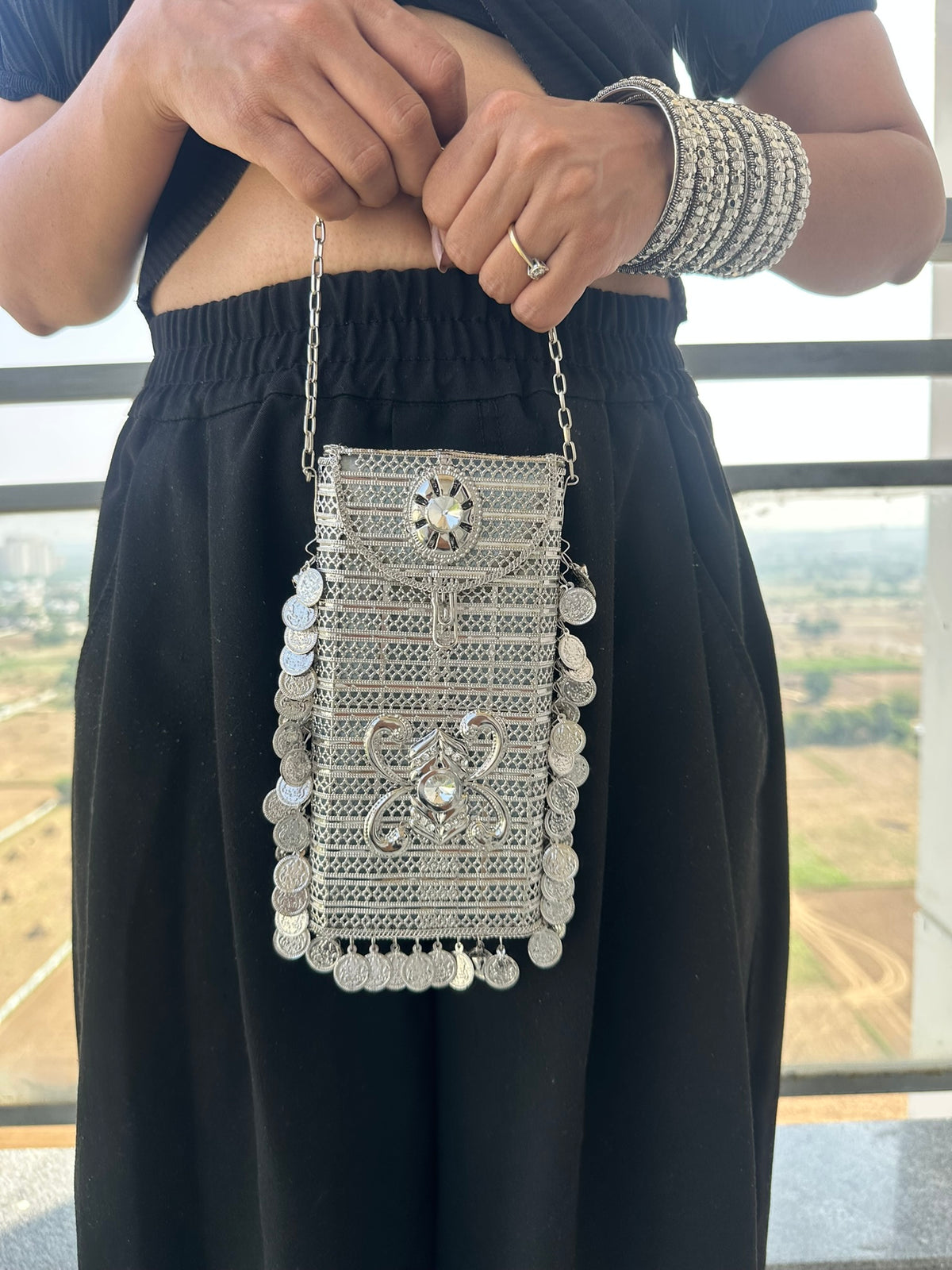 The SITARA Handcrafted Metal Phone Crossbody Clutch with Sunburst Crystal & Coin Charms