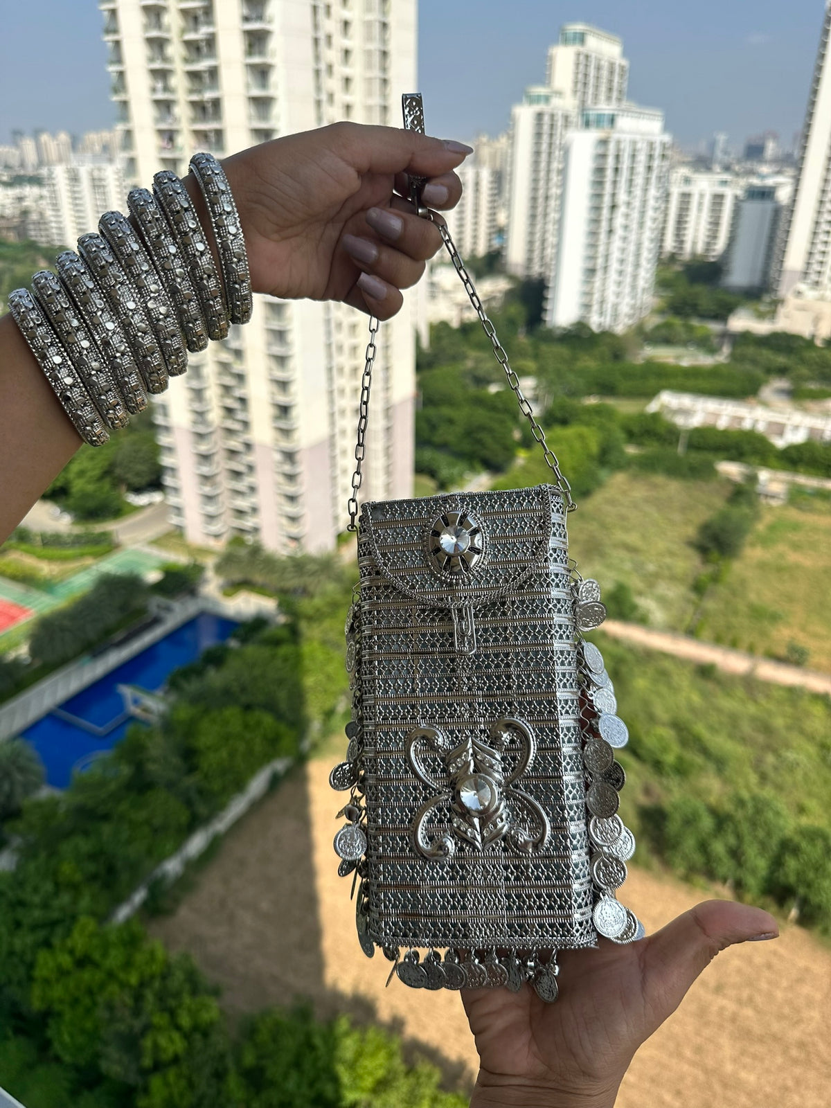 The SITARA Handcrafted Metal Phone Crossbody Clutch with Sunburst Crystal & Coin Charms