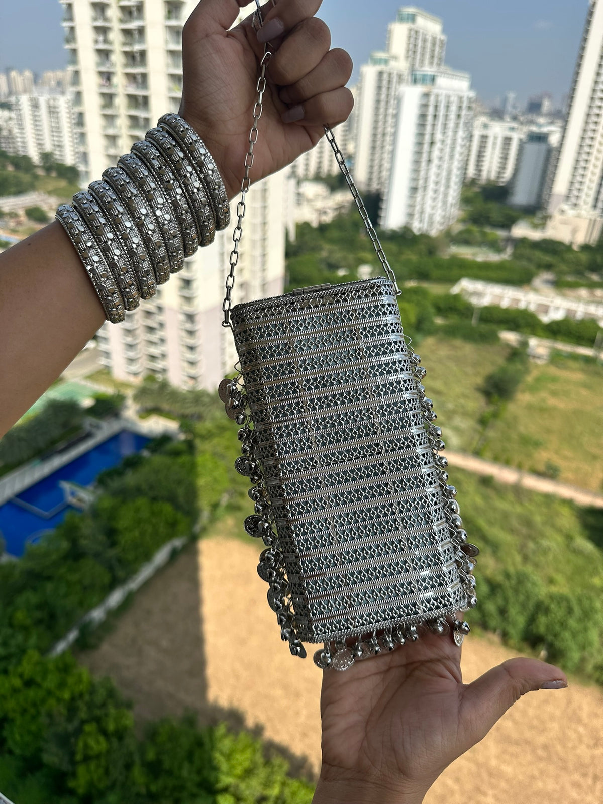 The SITARA Handcrafted Metal Phone Crossbody Clutch with Sunburst Crystal & Coin Charms