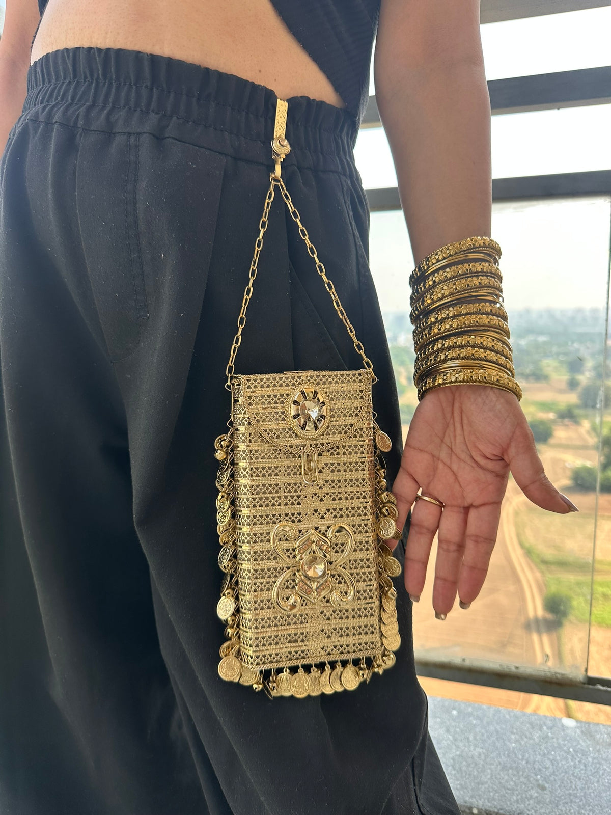 The SITARA Handcrafted Metal Phone Crossbody Clutch with Sunburst Crystal & Coin Charms