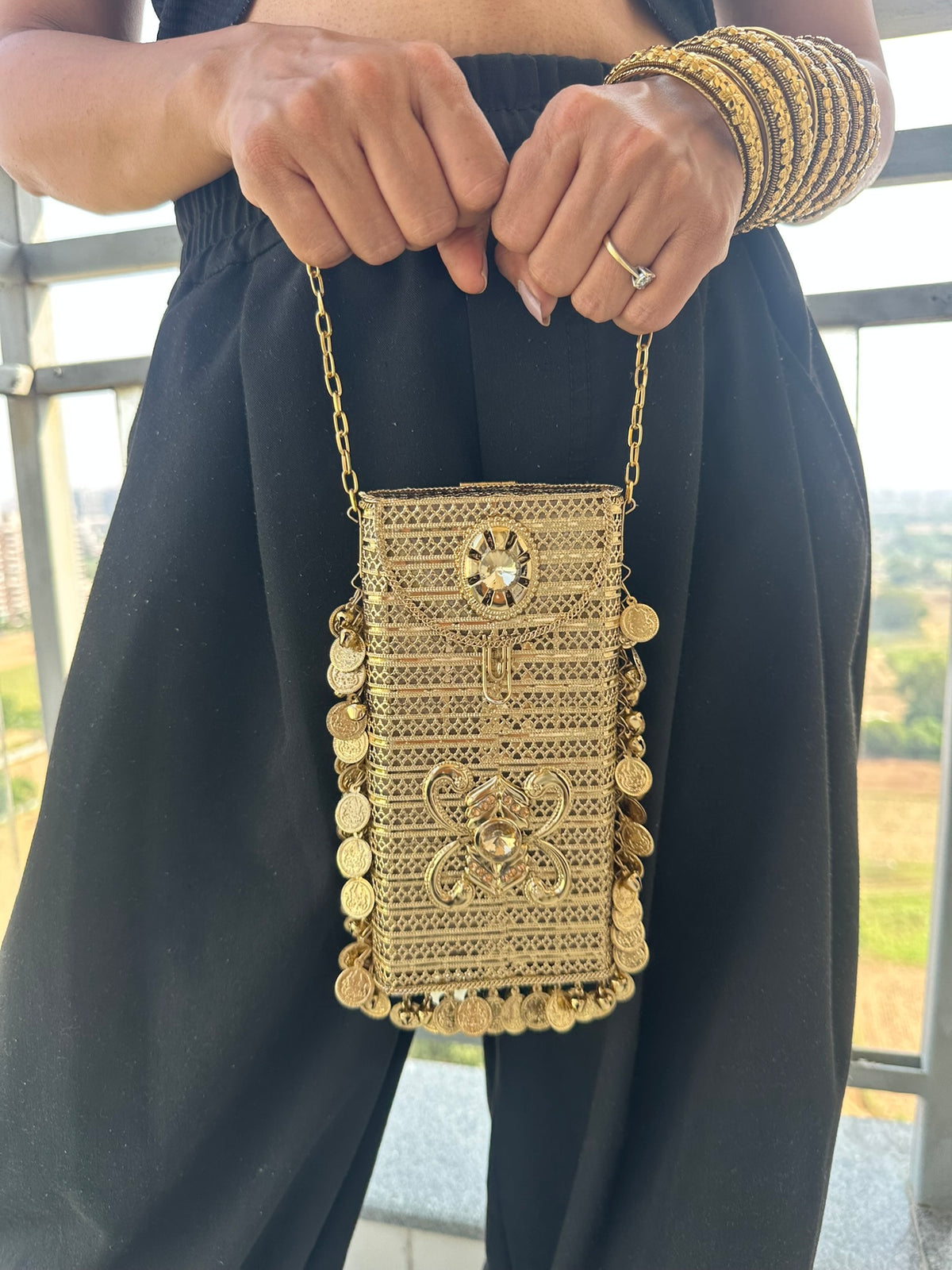 The SITARA Handcrafted Metal Phone Crossbody Clutch with Sunburst Crystal & Coin Charms