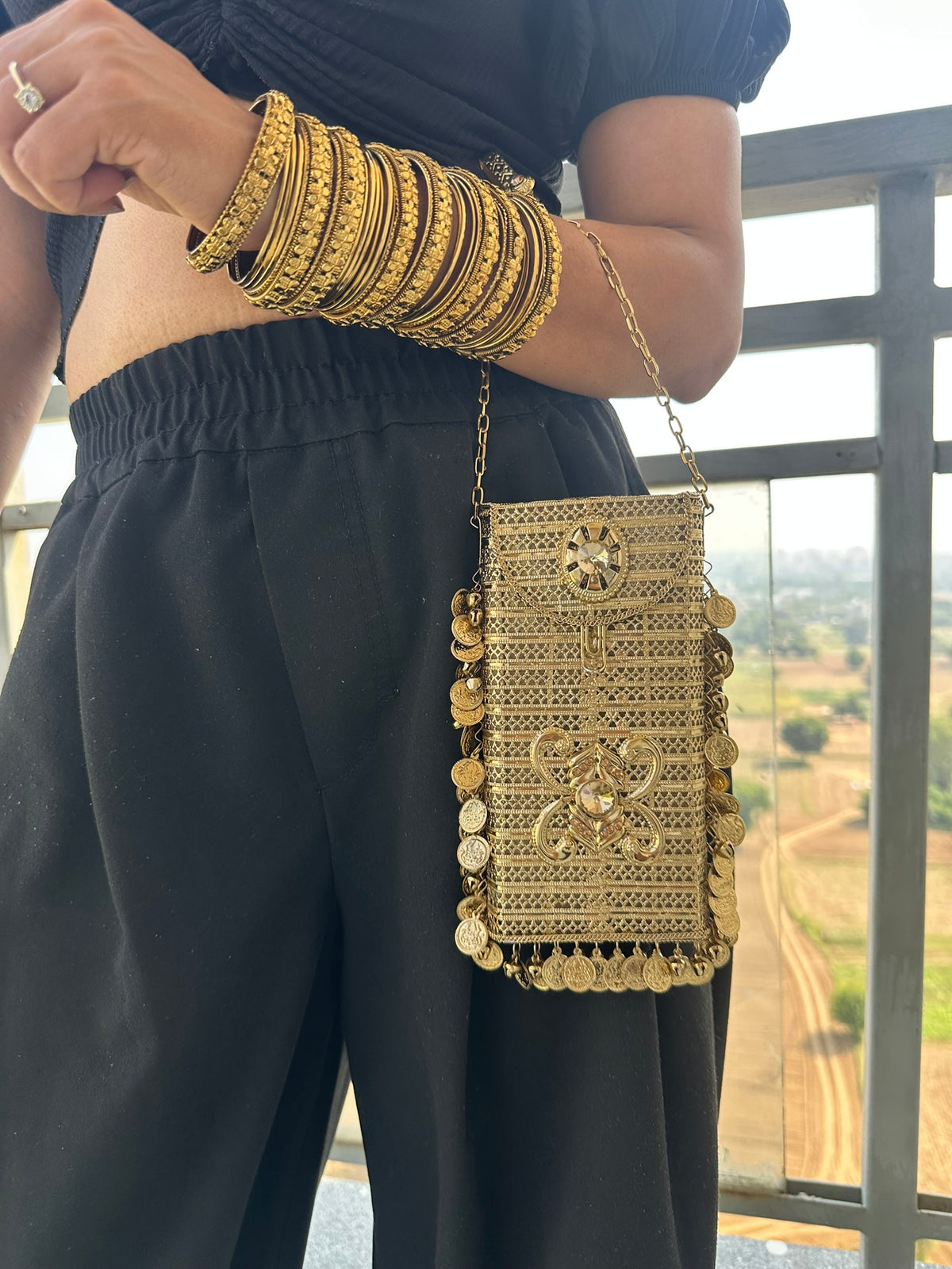 The SITARA Handcrafted Metal Phone Crossbody Clutch with Sunburst Crystal & Coin Charms