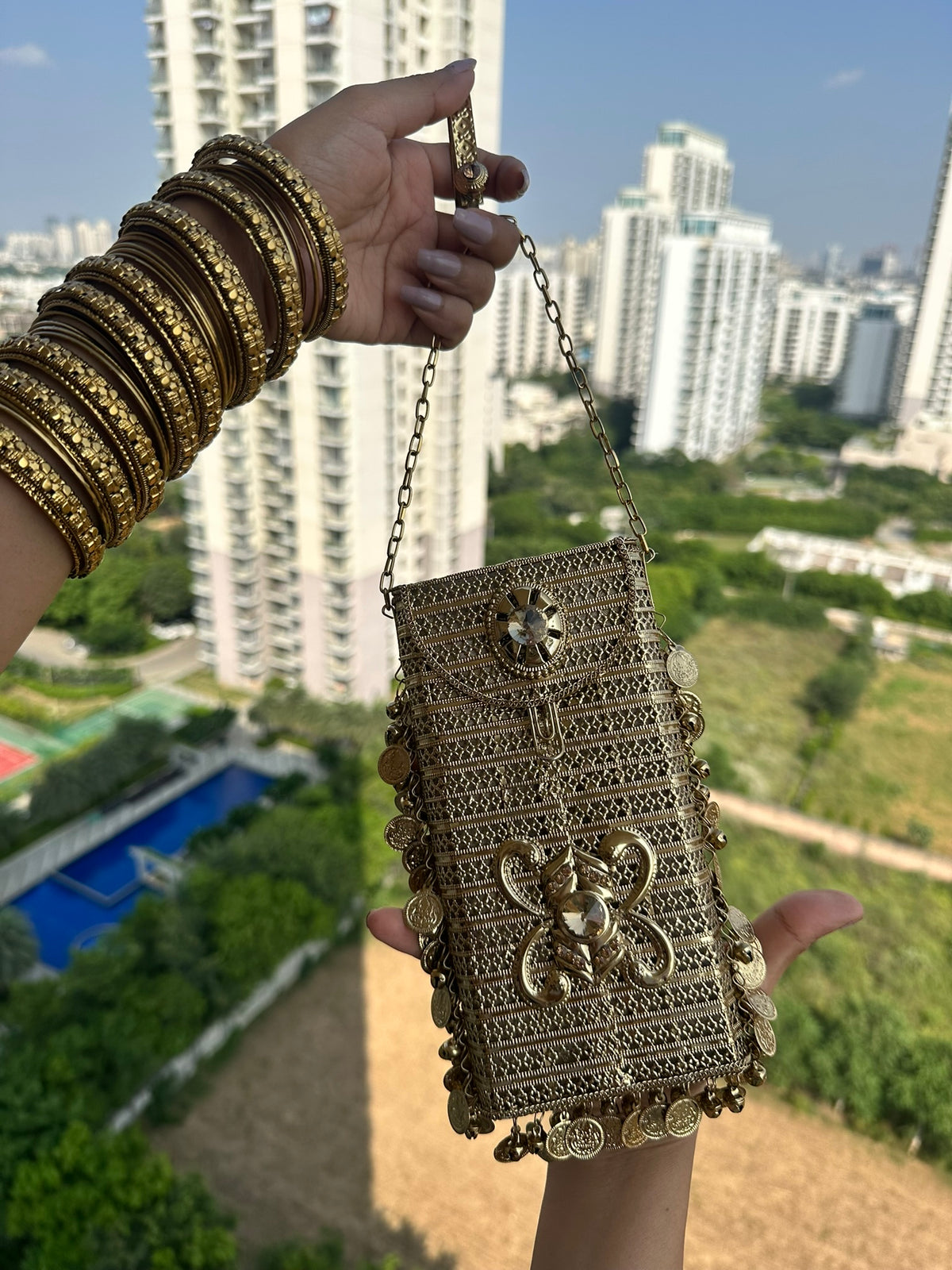 The SITARA Handcrafted Metal Phone Crossbody Clutch with Sunburst Crystal & Coin Charms
