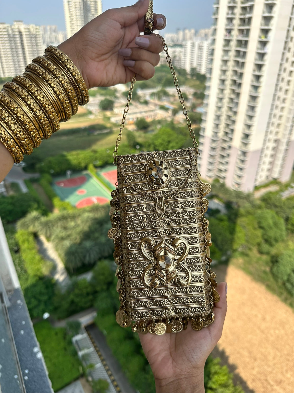 The SITARA Handcrafted Metal Phone Crossbody Clutch with Sunburst Crystal & Coin Charms