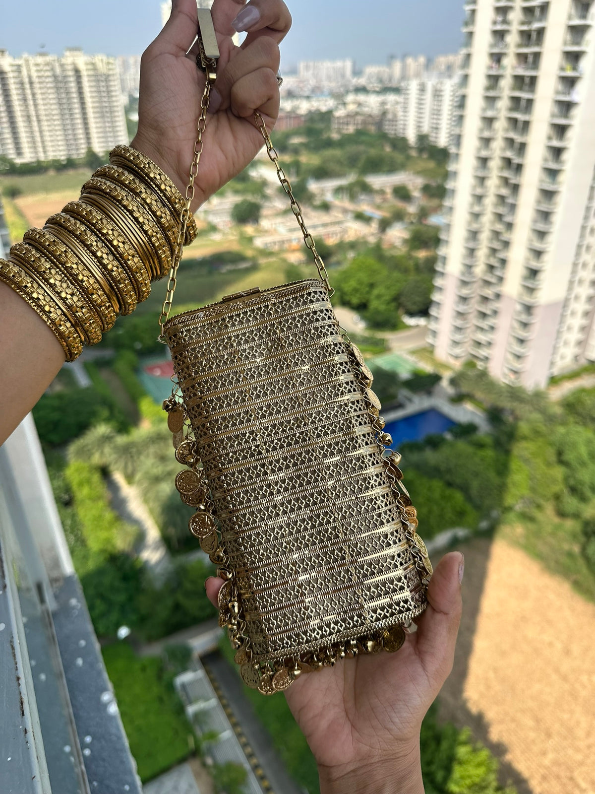 The SITARA Handcrafted Metal Phone Crossbody Clutch with Sunburst Crystal & Coin Charms