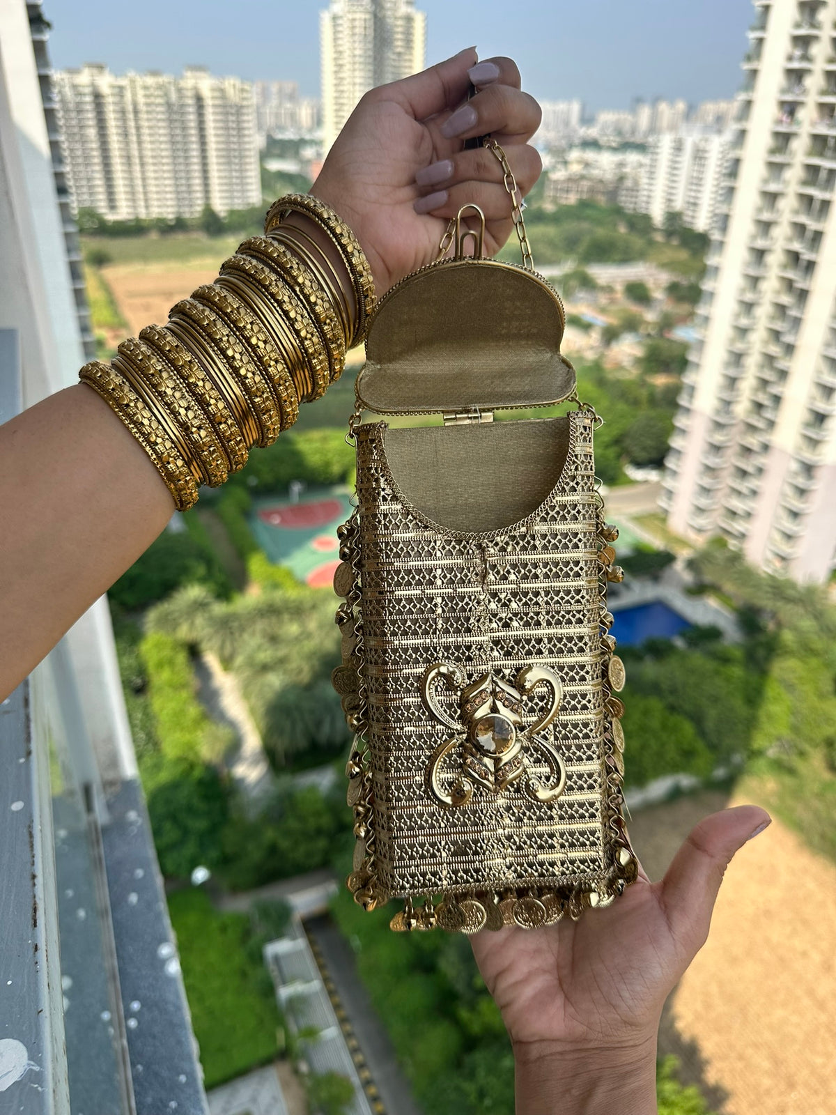The SITARA Handcrafted Metal Phone Crossbody Clutch with Sunburst Crystal & Coin Charms
