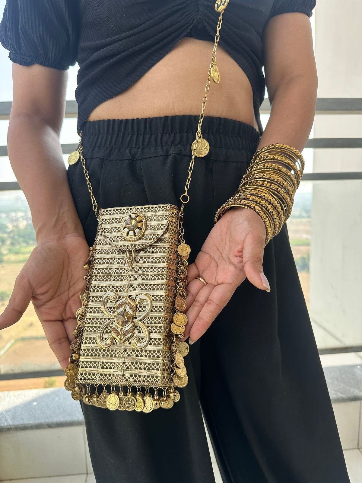 The SITARA Handcrafted Metal Phone Crossbody Clutch with Sunburst Crystal & Coin Charms