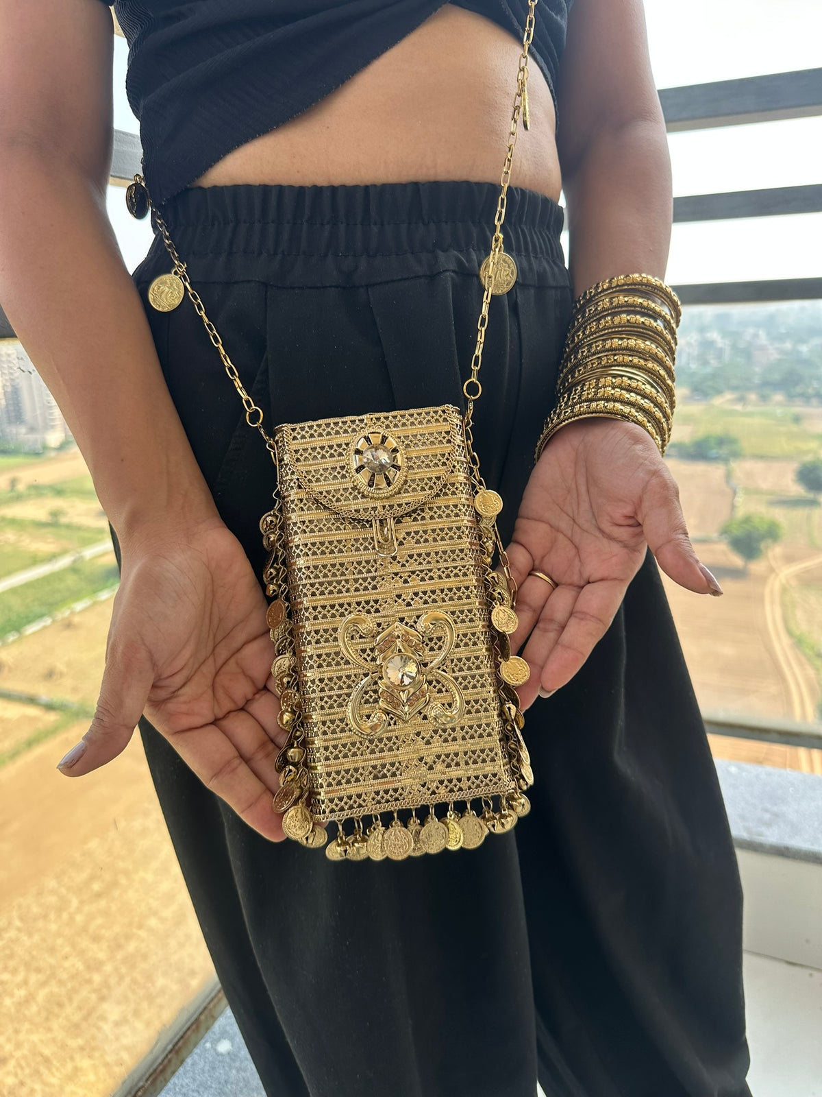 The SITARA Handcrafted Metal Phone Crossbody Clutch with Sunburst Crystal & Coin Charms