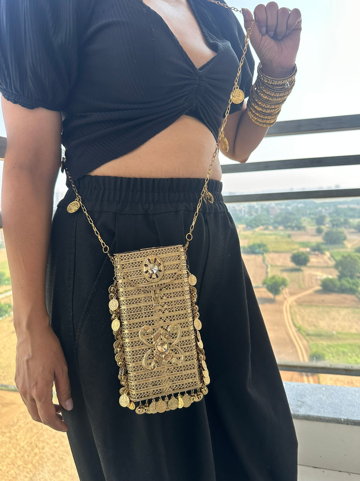 The SITARA Handcrafted Metal Phone Crossbody Clutch with Sunburst Crystal & Coin Charms