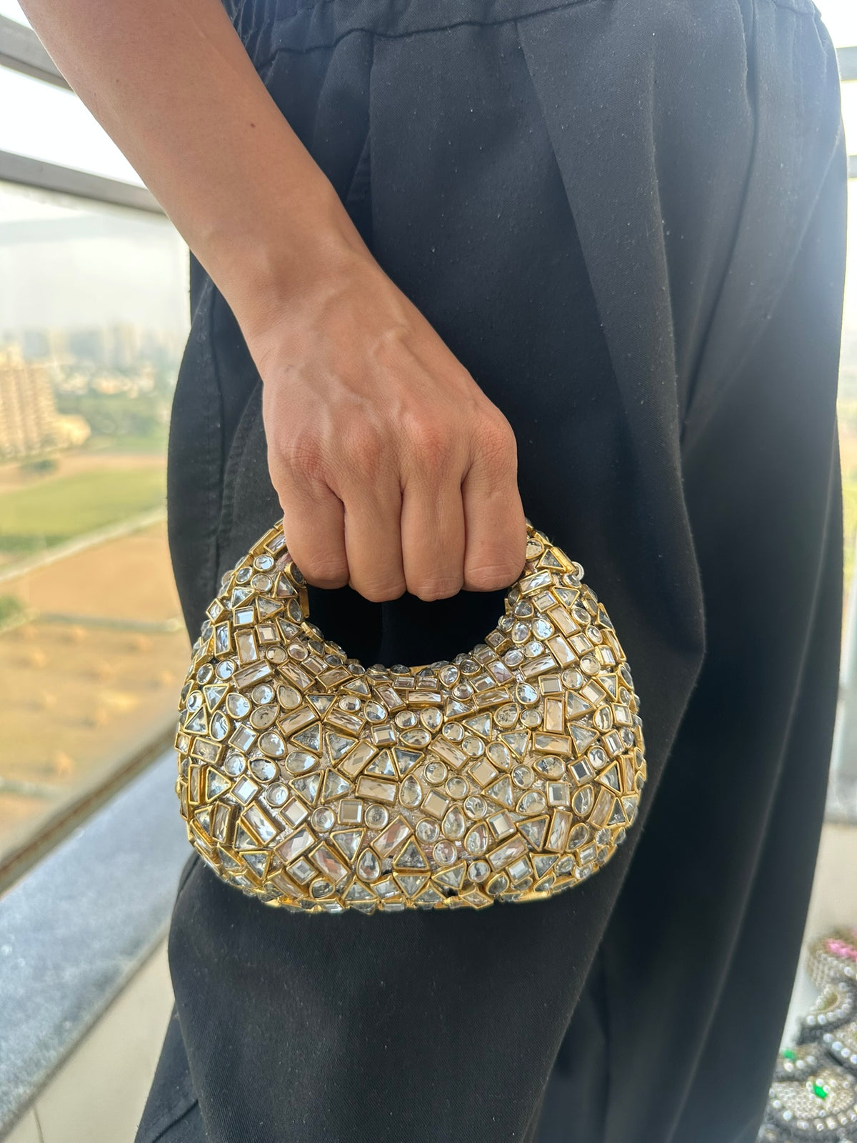 The TARA Handcrafted Mini Crescent Top-Handle Clutch with Charm Sling
