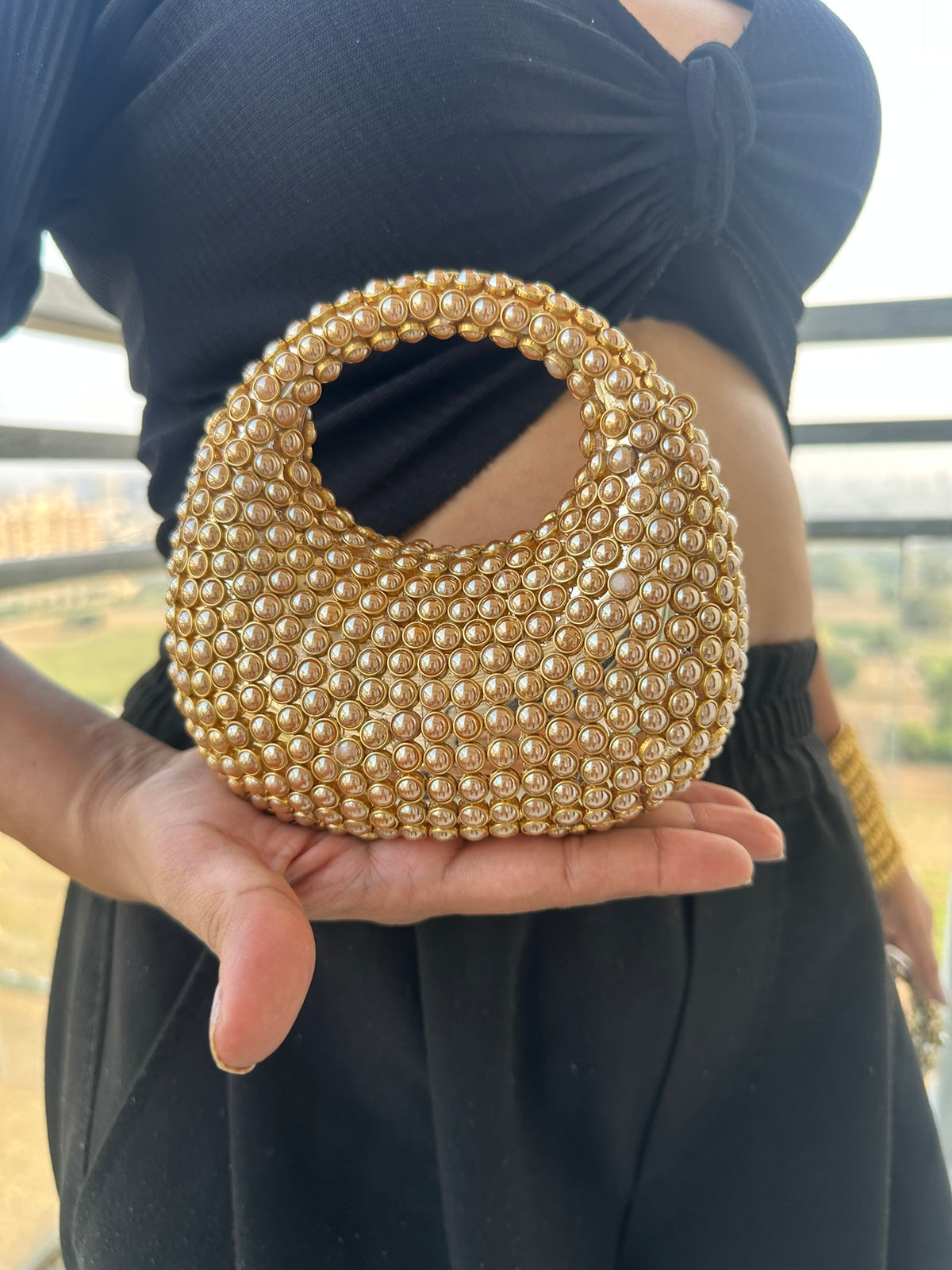 The TARA Handcrafted Mini Crescent Top-Handle Clutch with Charm Sling