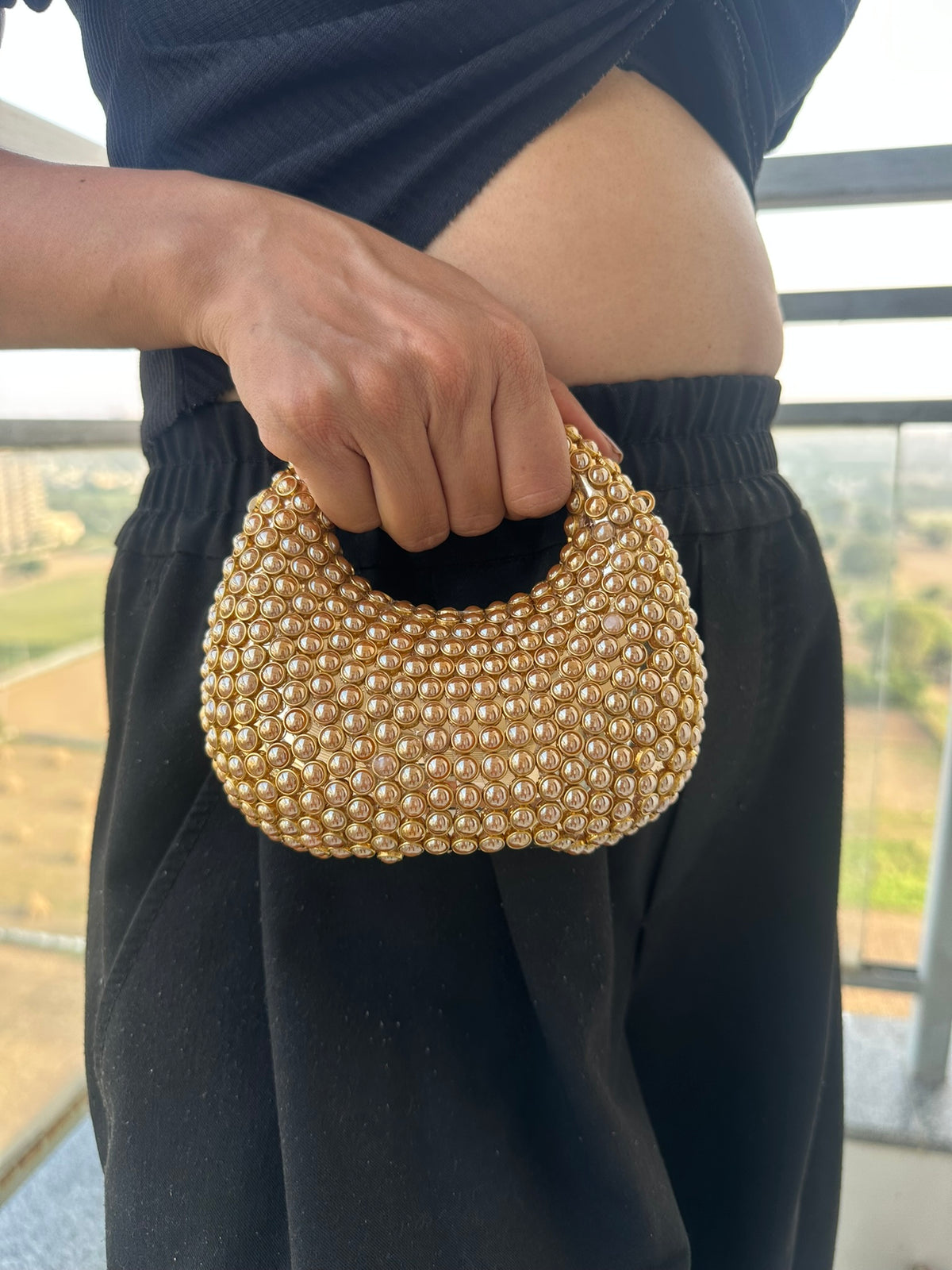 The TARA Handcrafted Mini Crescent Top-Handle Clutch with Charm Sling