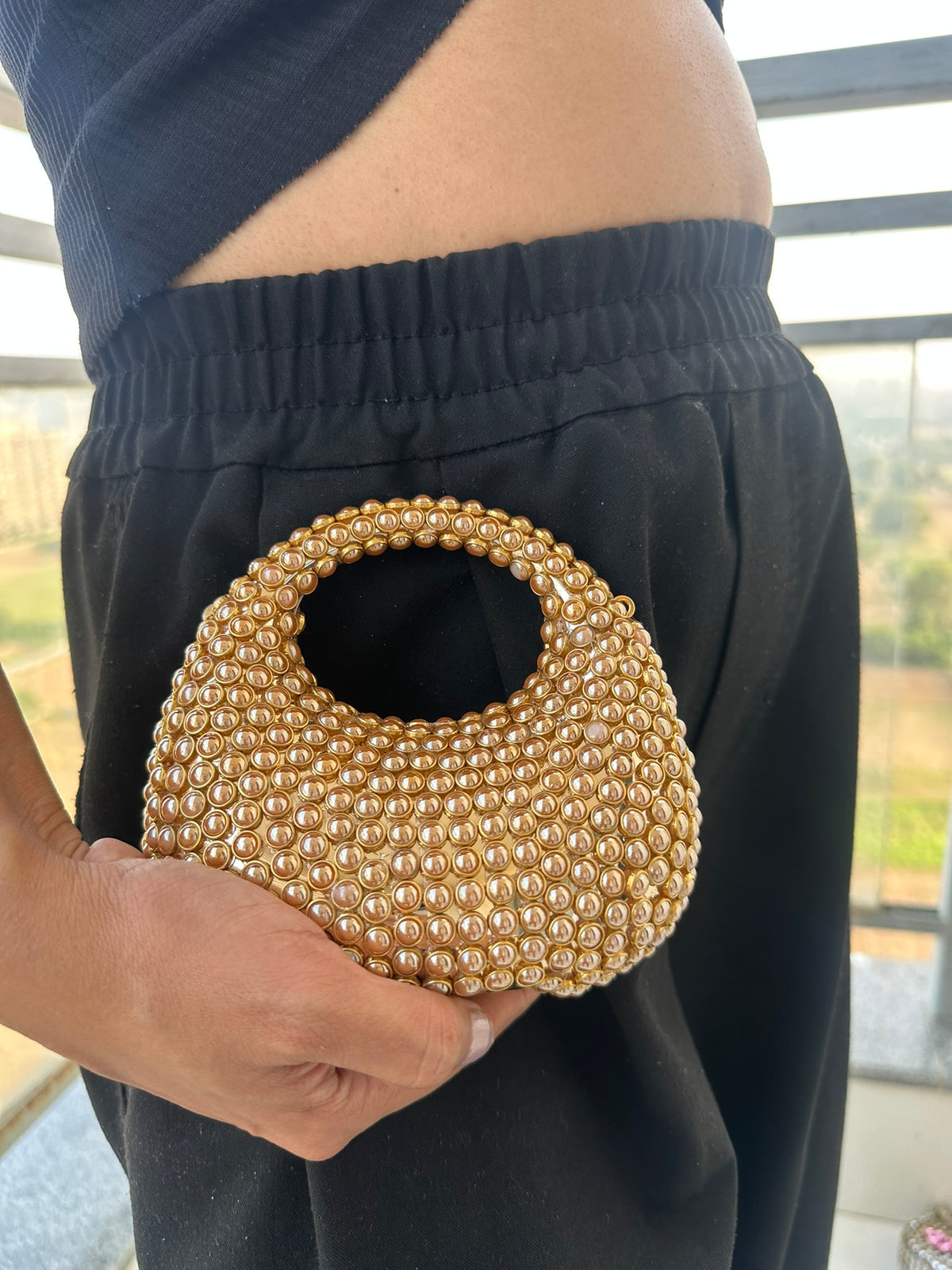 The TARA Handcrafted Mini Crescent Top-Handle Clutch with Charm Sling