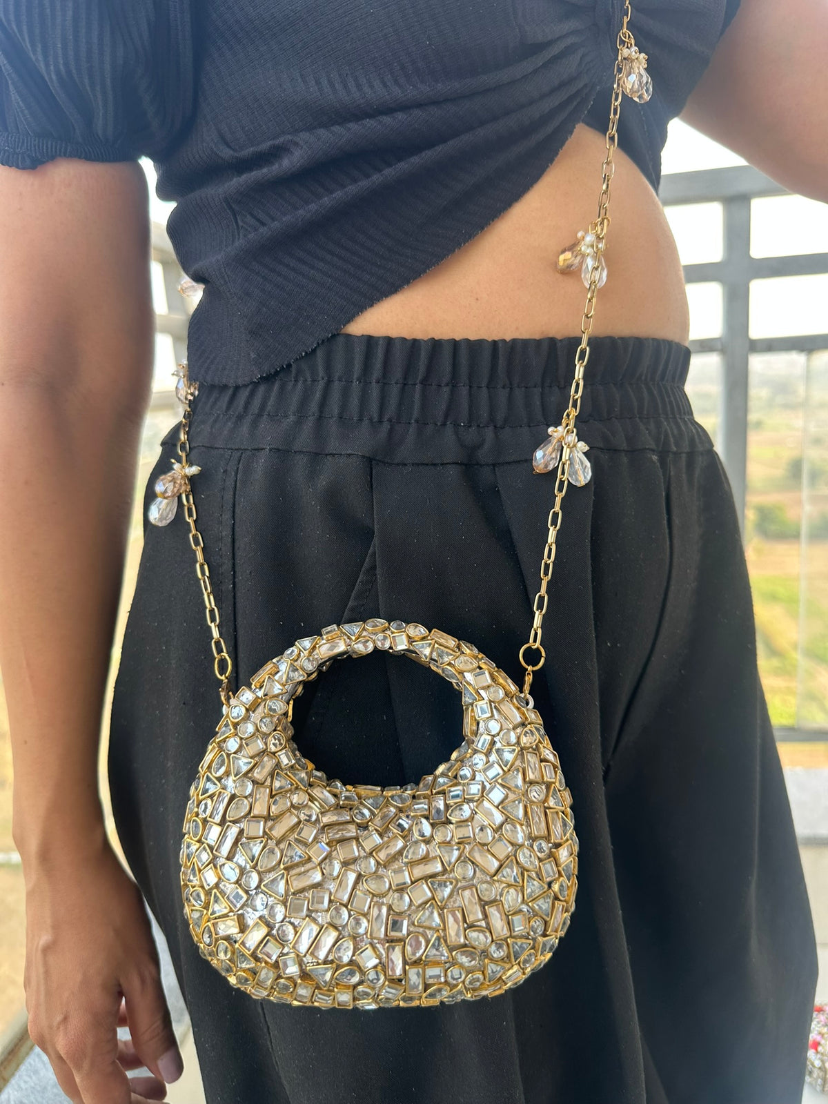 The TARA Handcrafted Mini Crescent Top-Handle Clutch with Charm Sling