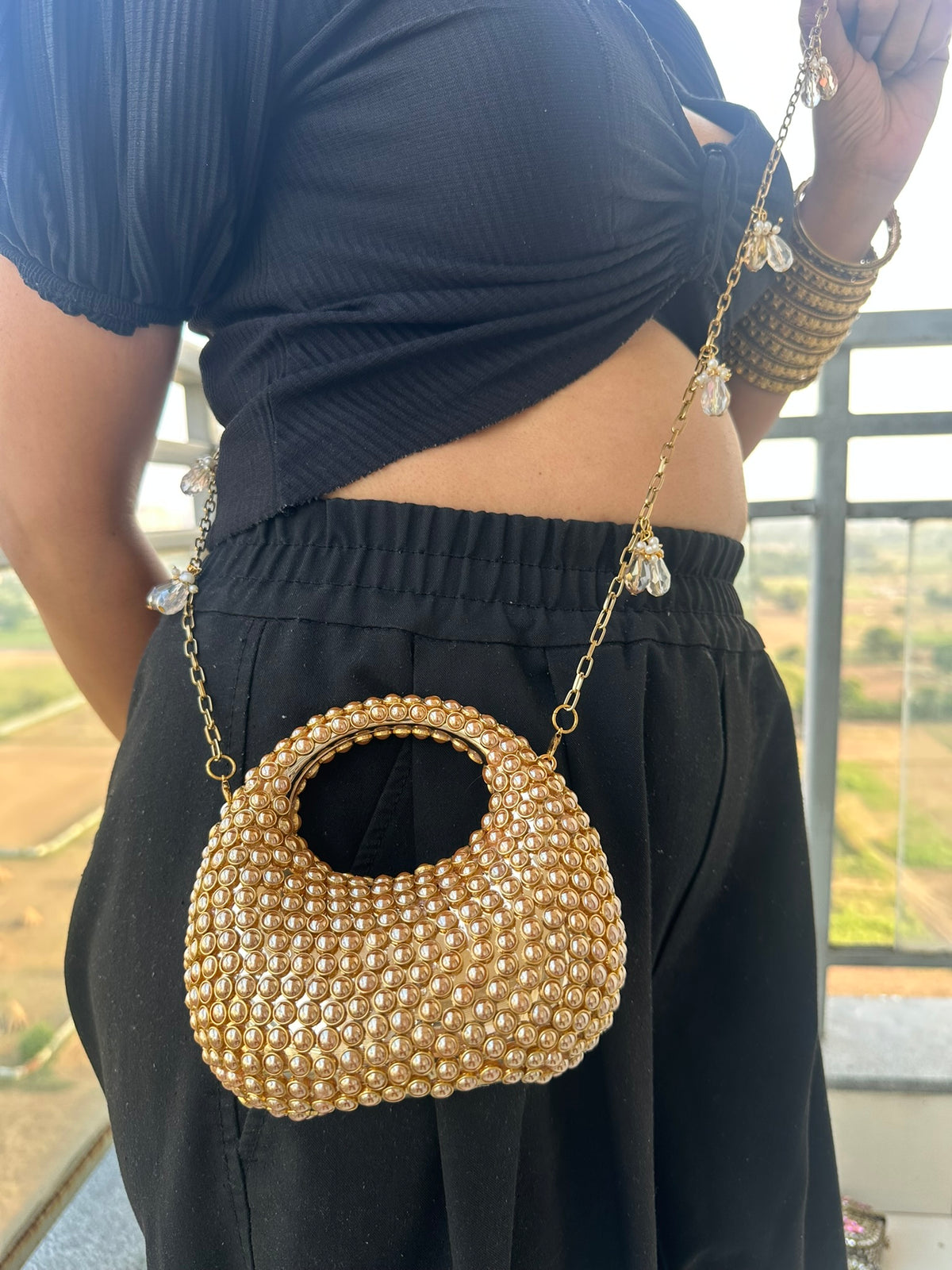 The TARA Handcrafted Mini Crescent Top-Handle Clutch with Charm Sling