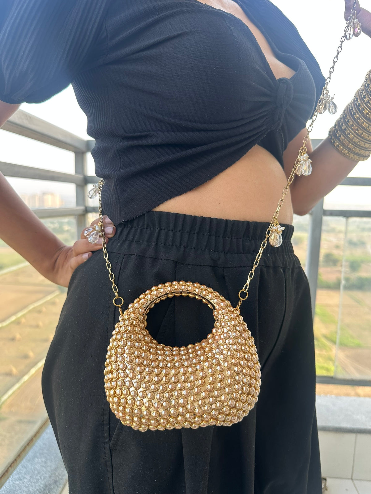 The TARA Handcrafted Mini Crescent Top-Handle Clutch with Charm Sling